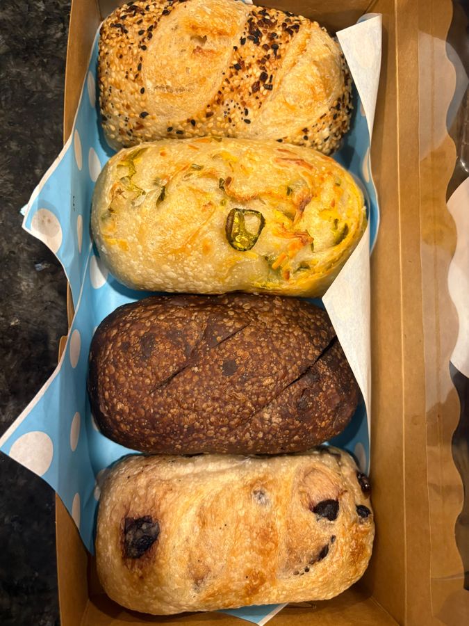 A box holding four different sourdough loaves