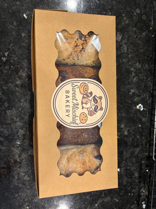 A kraft bakery box sealed with the raccoon label