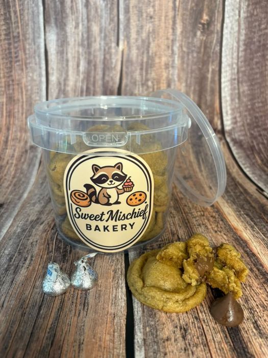 A sealed cookie bucket with cookies beside it